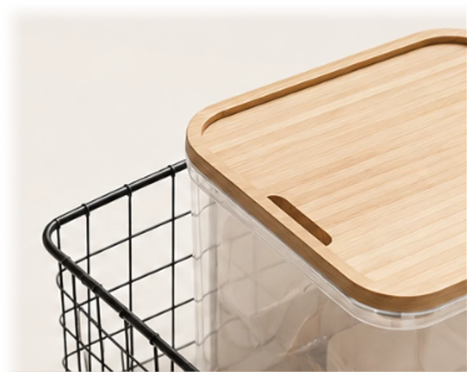 A wire basket and a clear storage bin with a bamboo lid